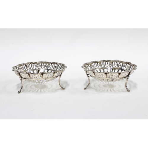 65 - Pair of George VI silver bonbon baskets, pierced design with three out-scrolling feet, Birmingham 19... 