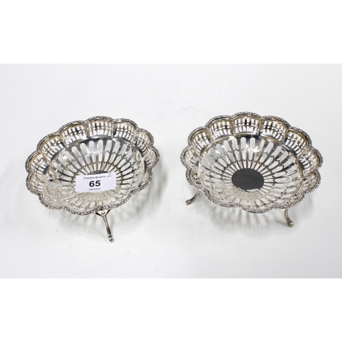 65 - Pair of George VI silver bonbon baskets, pierced design with three out-scrolling feet, Birmingham 19... 