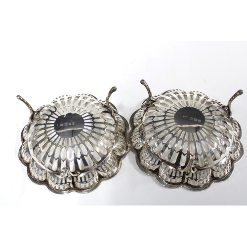 65 - Pair of George VI silver bonbon baskets, pierced design with three out-scrolling feet, Birmingham 19... 