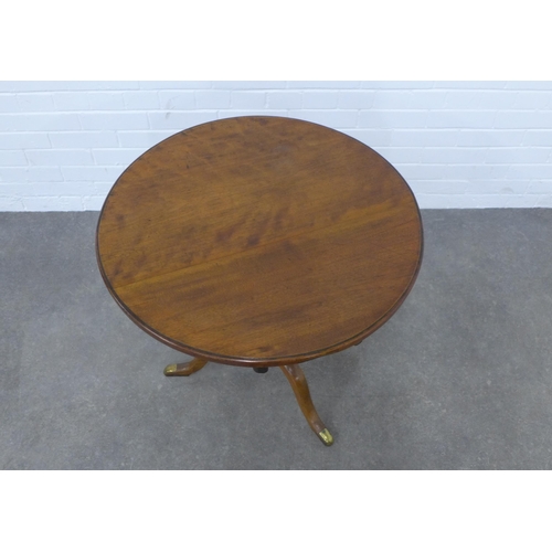 521 - Mahogany tilt top table, the circular top on a pedestal base with tripod legs with brass caps,  74 x... 