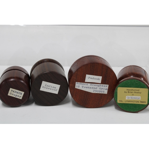 104 - A collection of artisan treen containers & vessels, woods include coconut palm, cocobolo & padauk, e... 