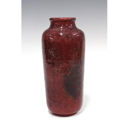 115 - HOLYROOD POTTERY cylindrical vase with a ruby red craquelure glaze, 11 x 24cm.