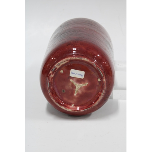 115 - HOLYROOD POTTERY cylindrical vase with a ruby red craquelure glaze, 11 x 24cm.