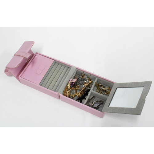 14 - A collection of costume jewellery brooches in a pink leather jewel box