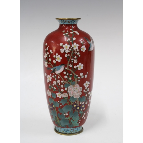 150 - Cloisonne vase with a pattern of birds perched on blossom branches against a red ground, 22cm high.