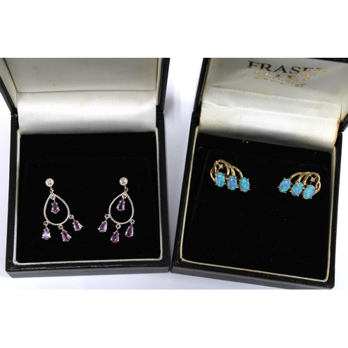 50 - A pair of opal earrings set in 9ct gold together with a pair of 9ct white gold gemset earrings (2)