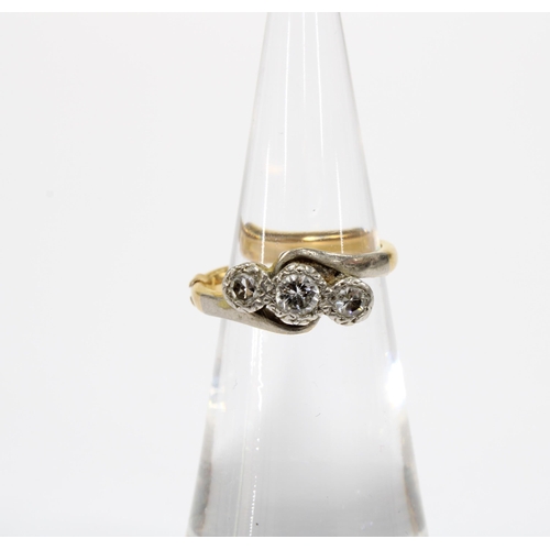 56 - Three stone diamond ring set in 18ct gold and platinum, with a 9ct section of ring sizer fitted