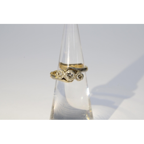 56 - Three stone diamond ring set in 18ct gold and platinum, with a 9ct section of ring sizer fitted