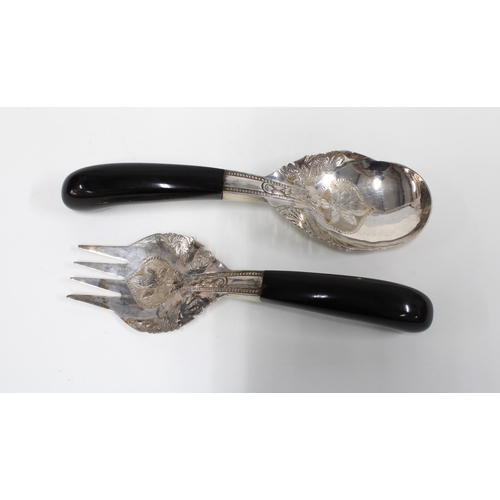 81 - A pair of Eastern white metal salad servers with ebonised wood handles (2)