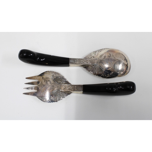 81 - A pair of Eastern white metal salad servers with ebonised wood handles (2)