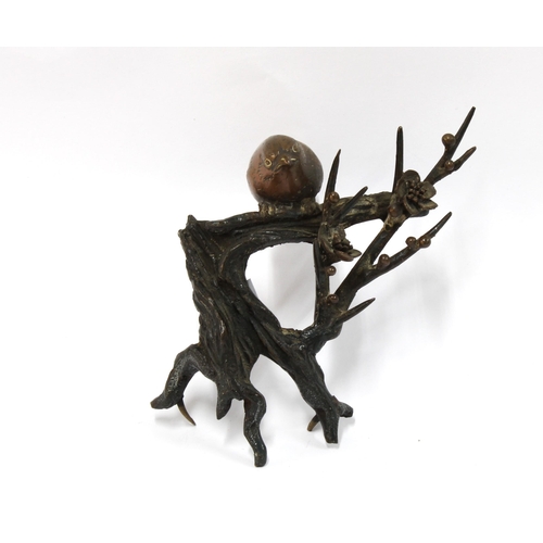 449 - Bronze study of a bird perched upon a flowering branch, (perhaps a finial) 15cm long