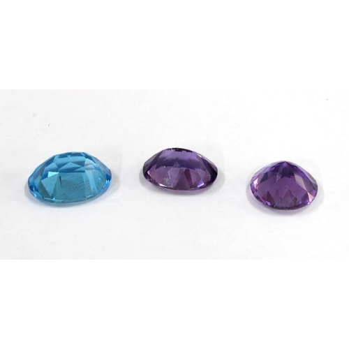 25 - Two unmounted amethysts, facet cut to include an oval, 19mm x 14mm and a circular stone 16mm diamete... 