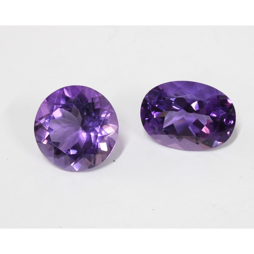 25 - Two unmounted amethysts, facet cut to include an oval, 19mm x 14mm and a circular stone 16mm diamete... 