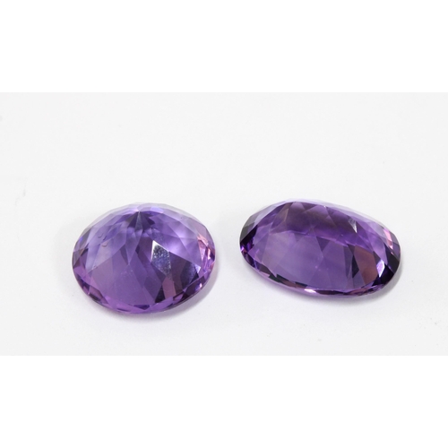 25 - Two unmounted amethysts, facet cut to include an oval, 19mm x 14mm and a circular stone 16mm diamete... 