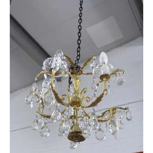 493 - A gilt brass chandelier light fitting with glass lustres, approx 55cm drop