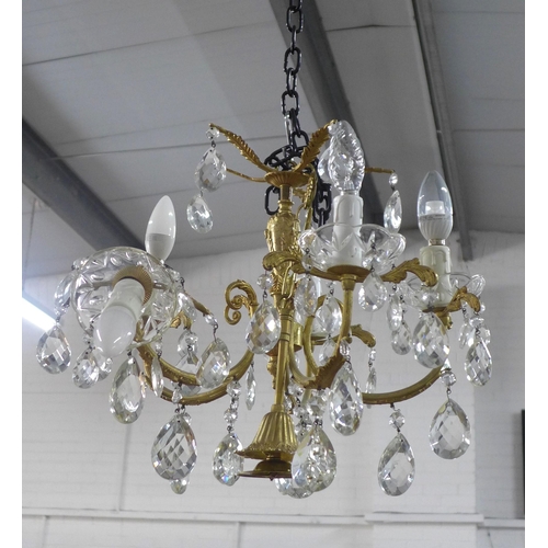 493 - A gilt brass chandelier light fitting with glass lustres, approx 55cm drop