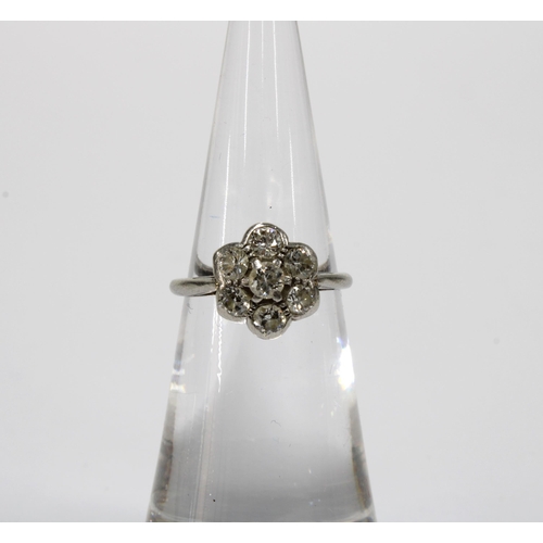 87 - Diamond flowerhead cluster ring, set with seven old cut diamonds, plain white metal band, unmarked, ... 