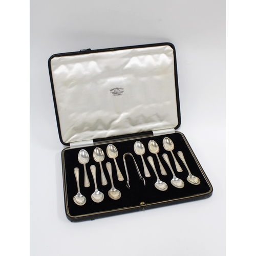 100 - A cased set of twelve silver teaspoons with matching sugar tongs,  Sheffield 1933