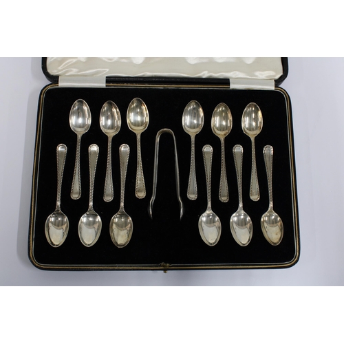 100 - A cased set of twelve silver teaspoons with matching sugar tongs,  Sheffield 1933