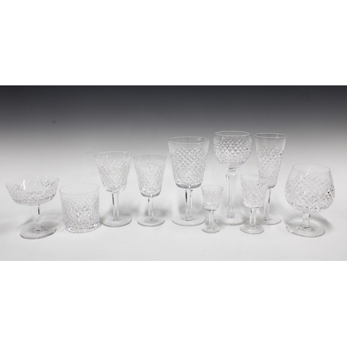 120 - Suite of Waterford crystal Alana pattern  drinking glasses, tallest glasses 19cm, two shelves, appro... 