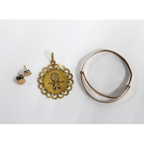 19 - Gold pendant, stamped 750, babies 9ct gold bangle and a pair of yellow metal earrings (3)