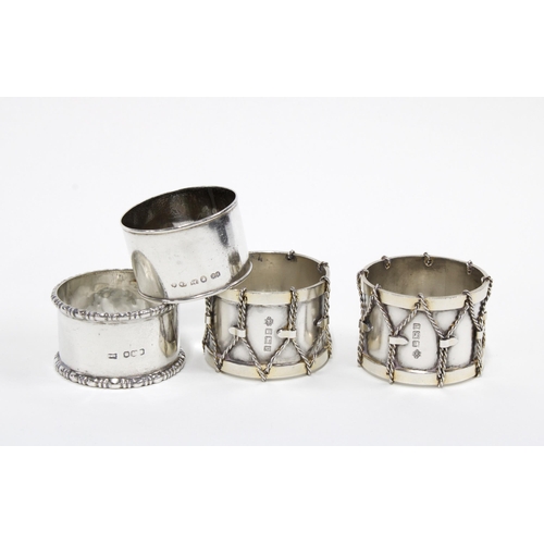 2 - A pair of Edwardian silver 'drum' napkin rings, William Hutton, Sheffield 1907 and two other silver ... 