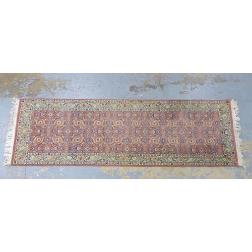 305 - Eastern wool runner with pink field and foliate pattern, 256 x 80cm