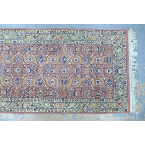 305 - Eastern wool runner with pink field and foliate pattern, 256 x 80cm