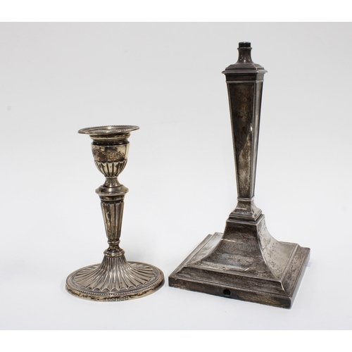 32 - An Edwardian silver candlestick, Sheffield 1904, 16cm high together with a silver lamp base (2)