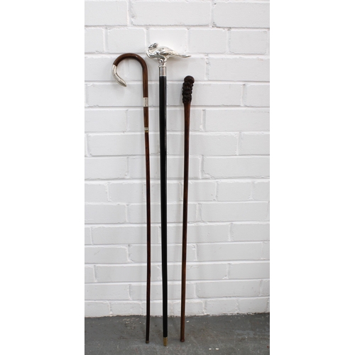 394 - Ebonised walking with with a white metal swan handle, 94cm, together with a burr handled stick and a... 