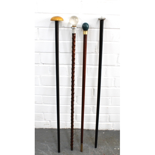 395 - Ebonised cane with domed treen handle, together with three others with pommel tops, longest 83cm