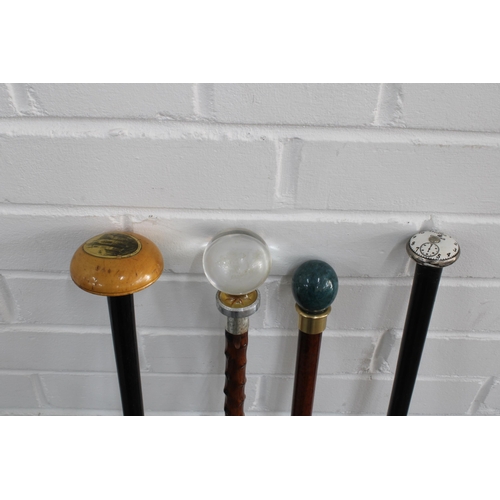 395 - Ebonised cane with domed treen handle, together with three others with pommel tops, longest 83cm