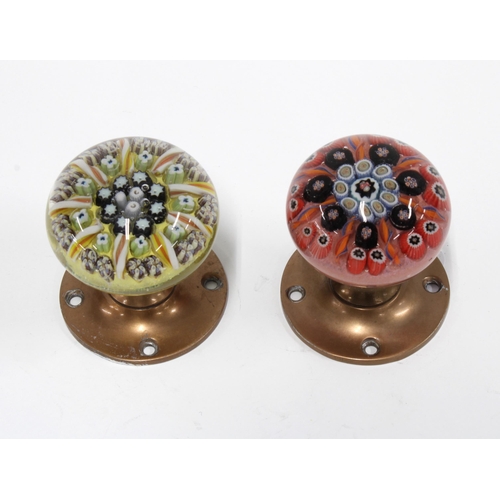 427 - A pair of millefiori glass door knobs with brass backplates, (2)