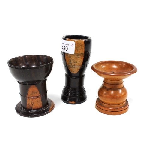 429 - Two treen pounce pots and a hardwood goblet, 12cm  (3)