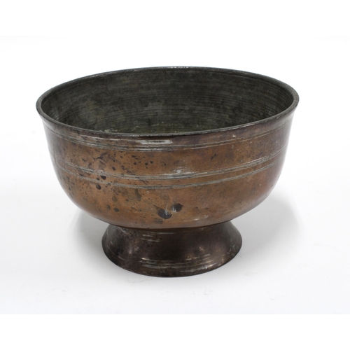 435 - An antique copper plated metal bowl on plain pedestal footrim with incised border, 14cm diameter