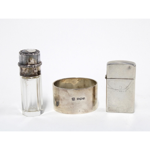 52 - Sterling silver Zippo lighter, a  silver napkin ring Sheffield 1933 and a glass scent bottle with wh... 