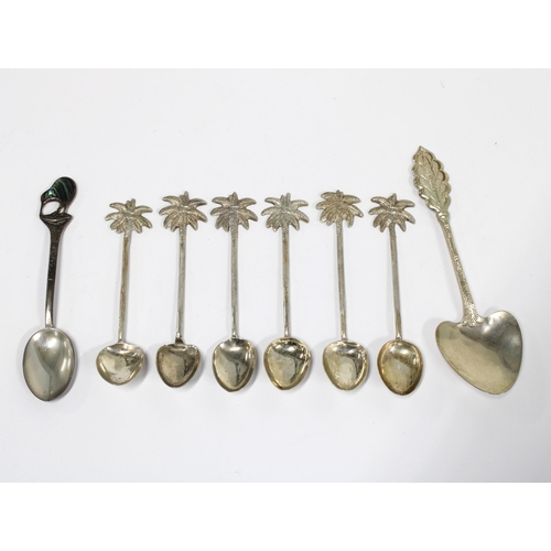 55 - Set of six white metal teaspoons with palm tree terminals, a New Zealand Sterling silver teaspoon an... 