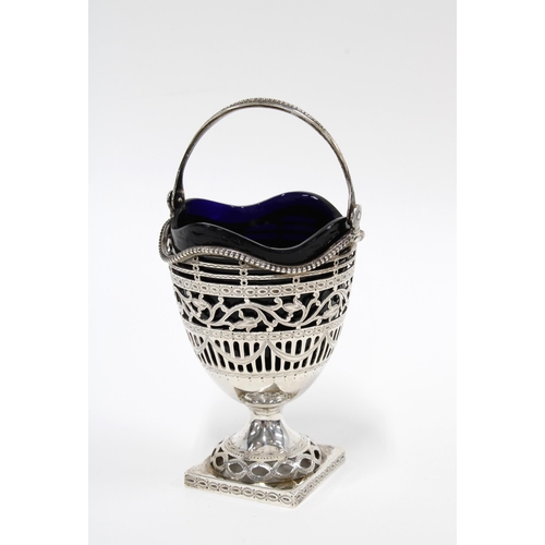 6 - A Georgian style  silver sugar basket with shaped blue glass liner,  London 1910, 16cm high includin... 