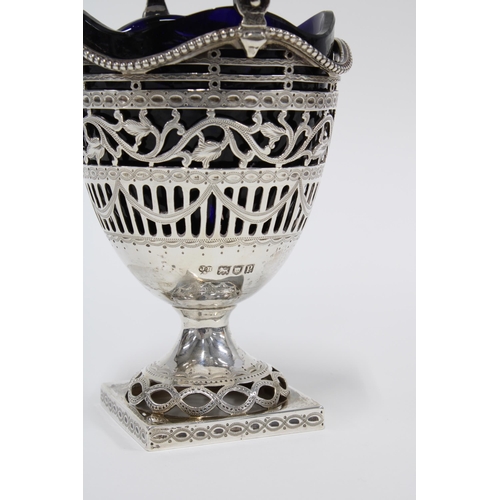 6 - A Georgian style  silver sugar basket with shaped blue glass liner,  London 1910, 16cm high includin... 