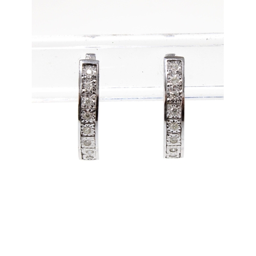 78 - A pair of 18ct white gold diamond set hoop earrings, stamped 750