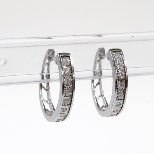 78 - A pair of 18ct white gold diamond set hoop earrings, stamped 750