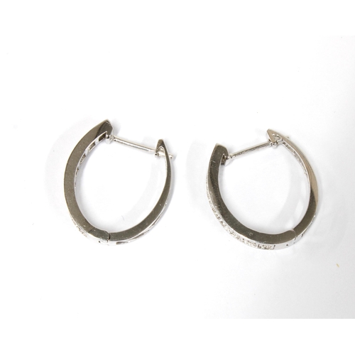 78 - A pair of 18ct white gold diamond set hoop earrings, stamped 750