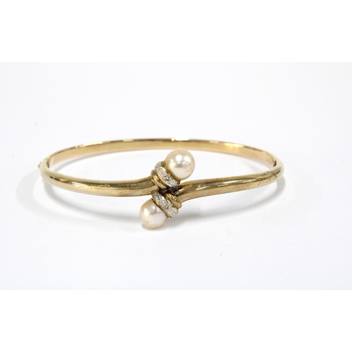 79 - Yellow metal bangle with pearls, indistinct marks to clasp