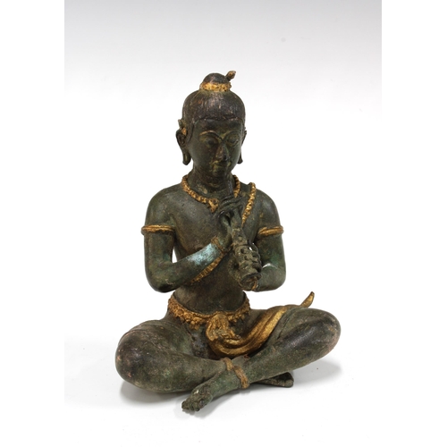 104 - Gilt bronze Buddha, modelled seated with a flute, 15cm