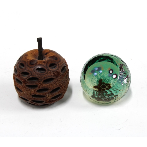 126 - Seed pod in the form of an apple, 9cm, together with a Caithness glass ocean scene glass paperweight... 