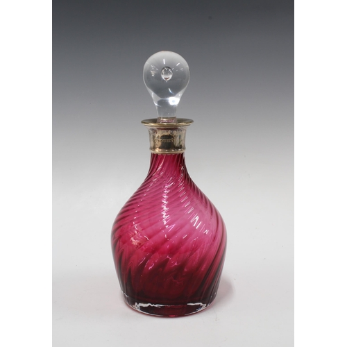 134 - Cranberry glass decanter with a silver collar and clear glass stopper, Birmingham 2002, 29cm