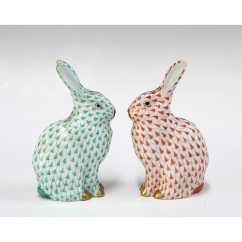 137 - Two Herend handpainted fishnet porcelain rabbits, one in green and the other red, with printed facto... 