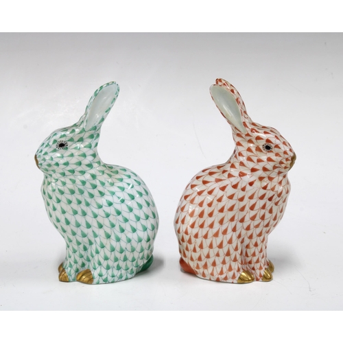 137 - Two Herend handpainted fishnet porcelain rabbits, one in green and the other red, with printed facto... 