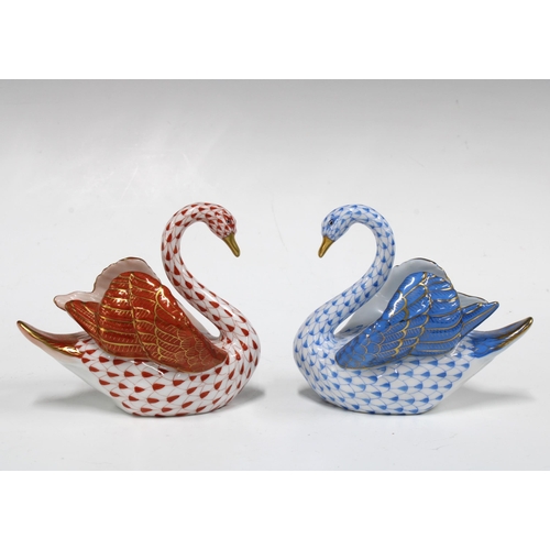 147 - Two Herend handpainted fishnet porcelain swans, one in blue and the other red, with printed factory ... 