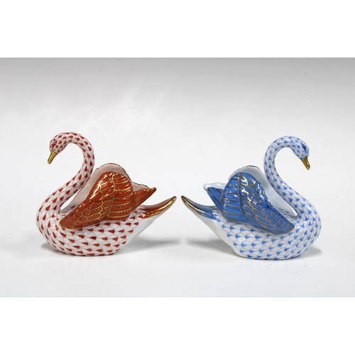 147 - Two Herend handpainted fishnet porcelain swans, one in blue and the other red, with printed factory ... 